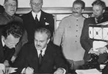 Роль И. В. Сталина в Великой Отечественной войне Foreign Minister Vyacheslav Molotov signs the pact. Behind him are Ribbentrop and Stalin